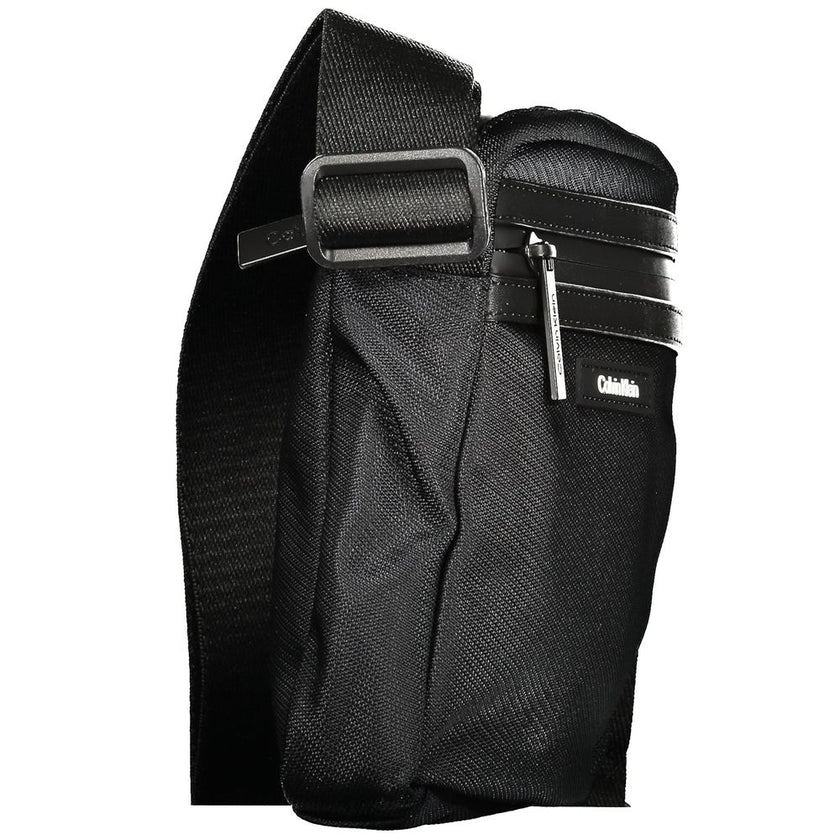 Black Polyester Men Shoulder BagElevate your accessory game with the sophisticated edge of a Calvin Klein shoulder bag, the perfect blend of functionality and sleek style. Boasting adjustable straps for a custom fit, this bag features two convenient exter