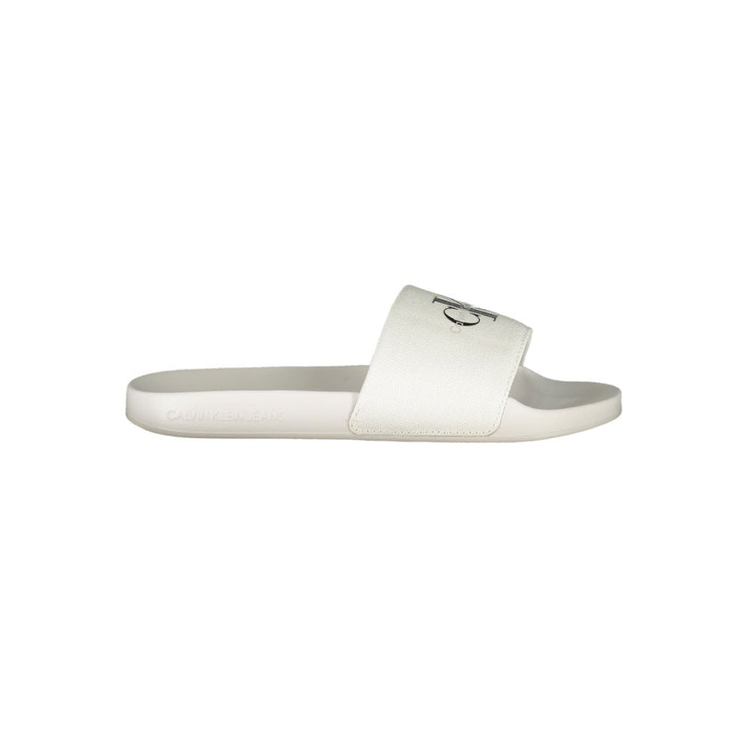 White Polyester Women SandalIndulge in the epitome of contemporary chic with these Calvin Klein logo-print sliders. Perfect for a stylish escape to the poolside or a casual stroll in the city, these sandals embody the effortless elegance synonymous with C
