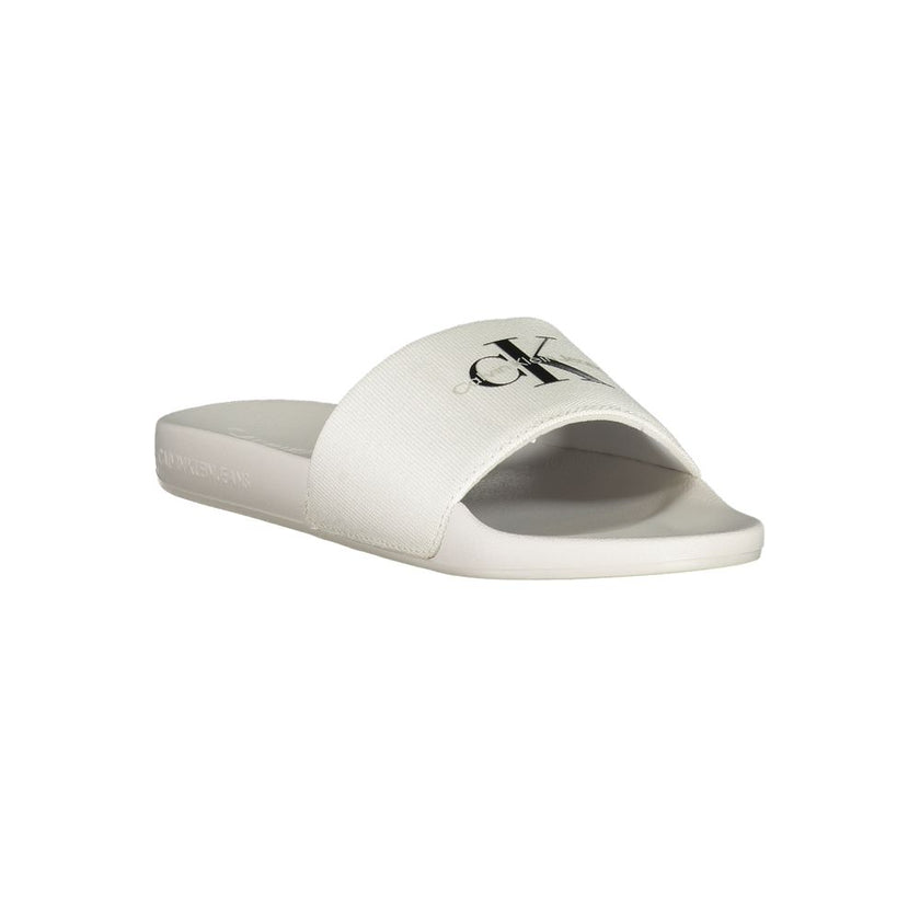 White Polyester Women SandalIndulge in the epitome of contemporary chic with these Calvin Klein logo-print sliders. Perfect for a stylish escape to the poolside or a casual stroll in the city, these sandals embody the effortless elegance synonymous with C