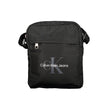 Black Polyester Men Shoulder BagElevate your accessory game with the sleek Calvin Klein Shoulder Bag, perfect for the modern trendsetter. Boasting a bold black hue and crafted with environmental consciousness in mind, this bag features a 95% recycled poly