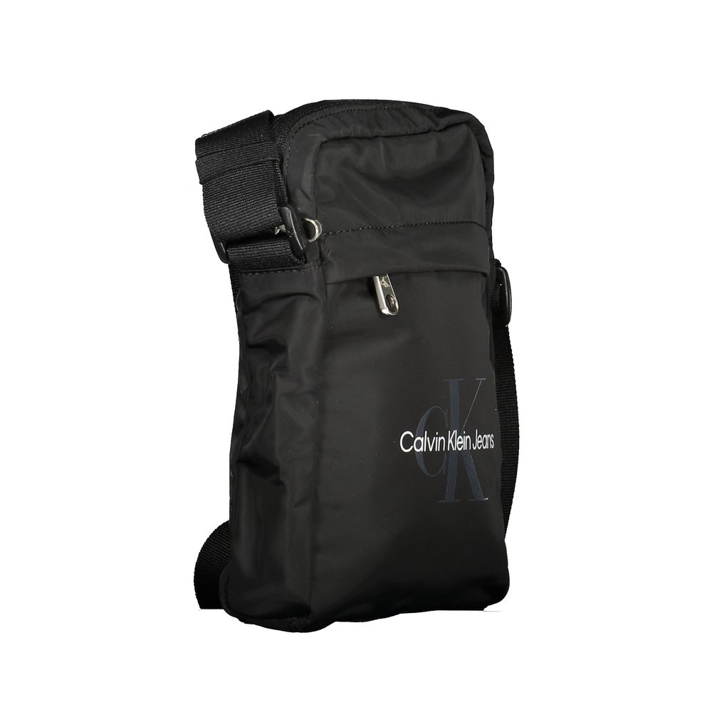 Black Polyester Men Shoulder BagElevate your accessory game with the sleek Calvin Klein Shoulder Bag, perfect for the modern trendsetter. Boasting a bold black hue and crafted with environmental consciousness in mind, this bag features a 95% recycled poly