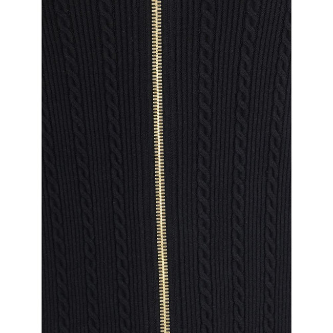 Gold Viscose Midi SkirtBalmain’s midi Skirt enhances the silhouette with a ribbed and twisted knit, giving structure and movement to the garment. On the front, the characteristic decorative 