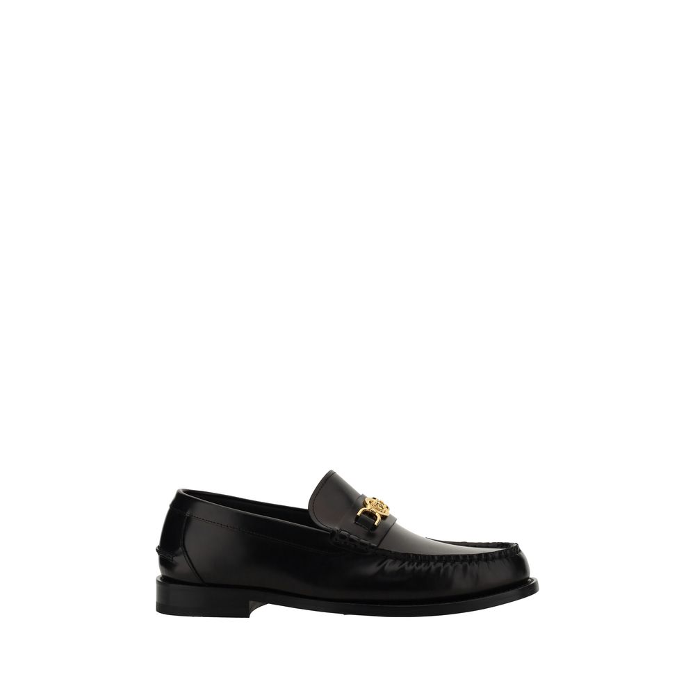 Black Calf Leather Bos Taurus Slip-On LoafersVersace’s leather Loafers combine classic elegance with iconic details. Featuring a slightly elongated round toe and a leather block heel, they feature a front tray embellished with a plaque featuring the iconi