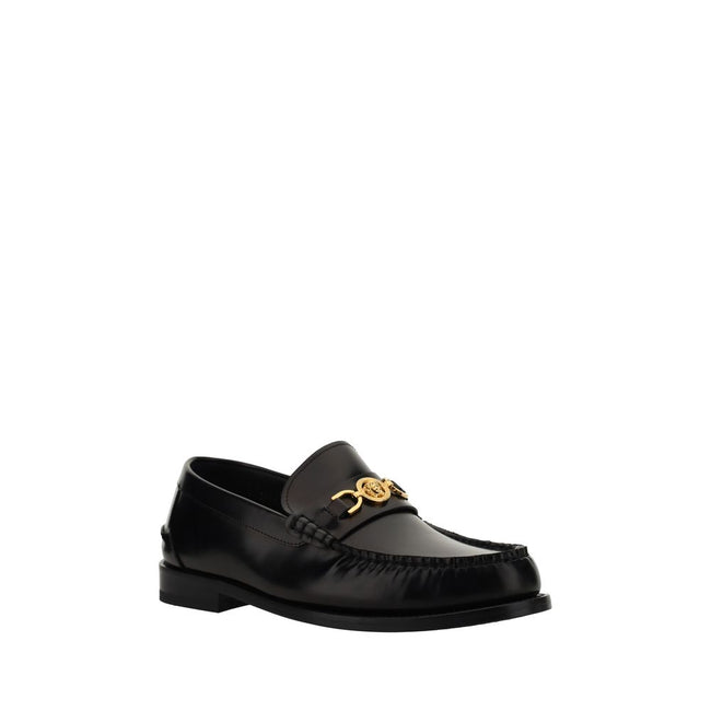 Black Calf Leather Bos Taurus Slip-On LoafersVersace’s leather Loafers combine classic elegance with iconic details. Featuring a slightly elongated round toe and a leather block heel, they feature a front tray embellished with a plaque featuring the iconi