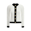 White Viscose CardiganBalmain’s Contrast Trim Cardigan features a ribbed and braided design enhanced by a silhouette-defining ribbed crew neck and hem. The front closure is embellished with embossed gold buttons, an iconic detail that adds a touch of luxu