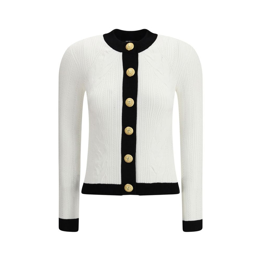 White Viscose CardiganBalmain’s Contrast Trim Cardigan features a ribbed and braided design enhanced by a silhouette-defining ribbed crew neck and hem. The front closure is embellished with embossed gold buttons, an iconic detail that adds a touch of luxu