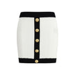 White Viscose Mini SkirtBalmain’s mini Skirt enhances the silhouette with a refined ribbed knit. Decorative gold metal 
