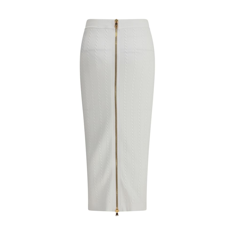 White Viscose Midi SkirtBalmain’s midi Skirt enhances the silhouette with a ribbed and twisted knit, giving structure and movement to the garment. On the front, the characteristic decorative 