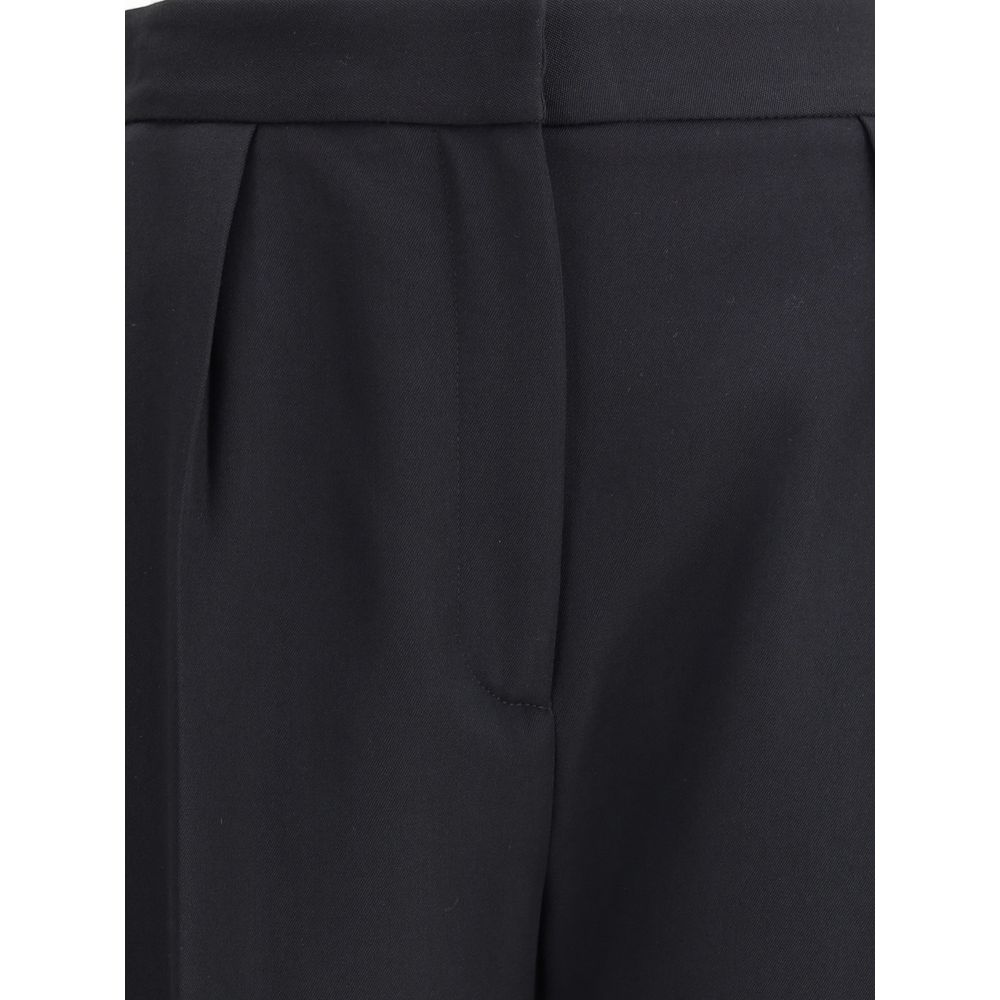 Black Wool Dress PantsBalmain’s grain de poudre tailored Pants express elegance and rigor with an impeccable cut. Featuring a sash at the waist, they feature a concealed zipper and hook-and-eye closure under the flap and ironed pleats at the front, which