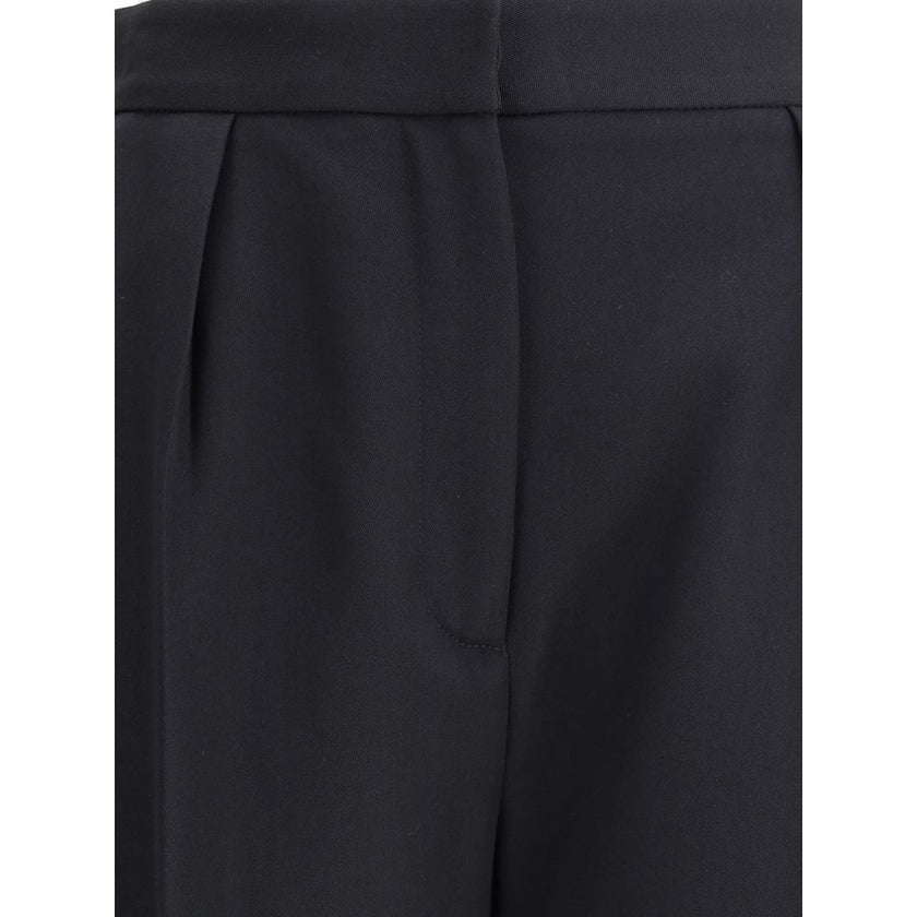 Black Wool Dress PantsBalmain’s grain de poudre tailored Pants express elegance and rigor with an impeccable cut. Featuring a sash at the waist, they feature a concealed zipper and hook-and-eye closure under the flap and ironed pleats at the front, which