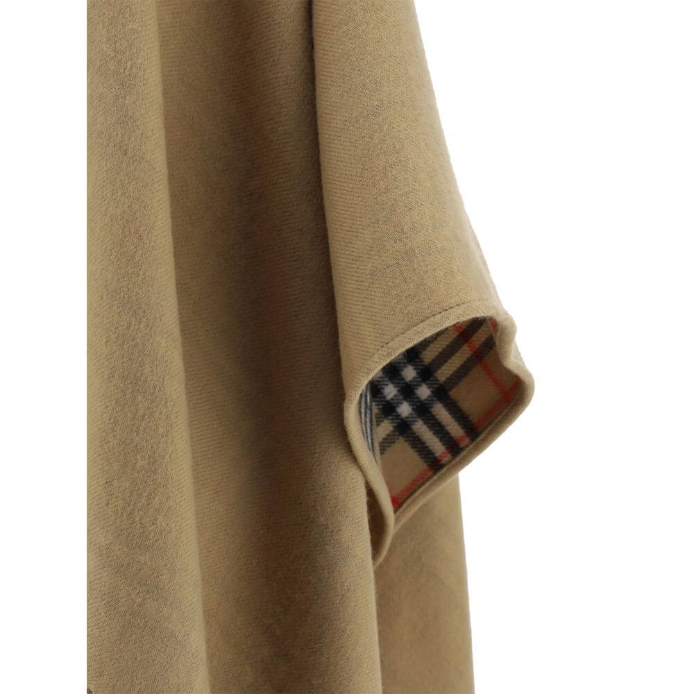 Brown Merino Wool CoatMerino Wool Cape by Burberry, monochrome cape design, shawl lapels, frayed hem, patterned Archivio Check interior, oversize fit. Season: AW25 Composition: GENERAL 100% Merino Wool MADE IN GREAT BRITAINBrown Merino Wool Coat${tagsBurb