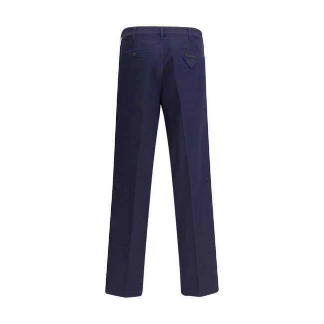 Blue Cotton Chino PantsPrada’s chino Pants offer essential elegance with contemporary style. Featuring a front zipper and button closure, they feature two side welt pockets and back pockets, one of which is embellished with the brand’s iconic logo. Waist