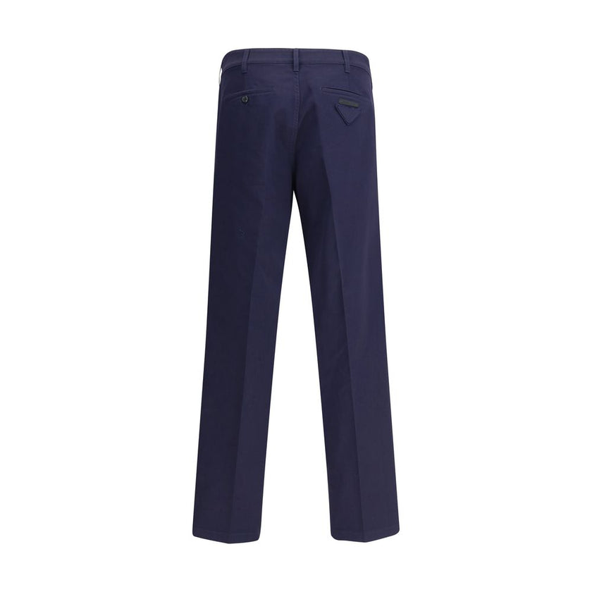Blue Cotton Chino PantsPrada’s chino Pants offer essential elegance with contemporary style. Featuring a front zipper and button closure, they feature two side welt pockets and back pockets, one of which is embellished with the brand’s iconic logo. Waist