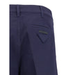Blue Cotton Chino PantsPrada’s chino Pants offer essential elegance with contemporary style. Featuring a front zipper and button closure, they feature two side welt pockets and back pockets, one of which is embellished with the brand’s iconic logo. Waist