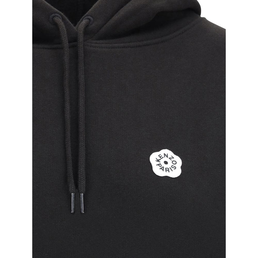 Black Cotton SweatshirtKenzo’s cotton Hoodie combines comfort and iconic style in a relaxed, contemporary design. Made of soft cotton that is internally plush, it features an adjustable drawstring hood and ribbed cuffs and hem for a structured finish. The