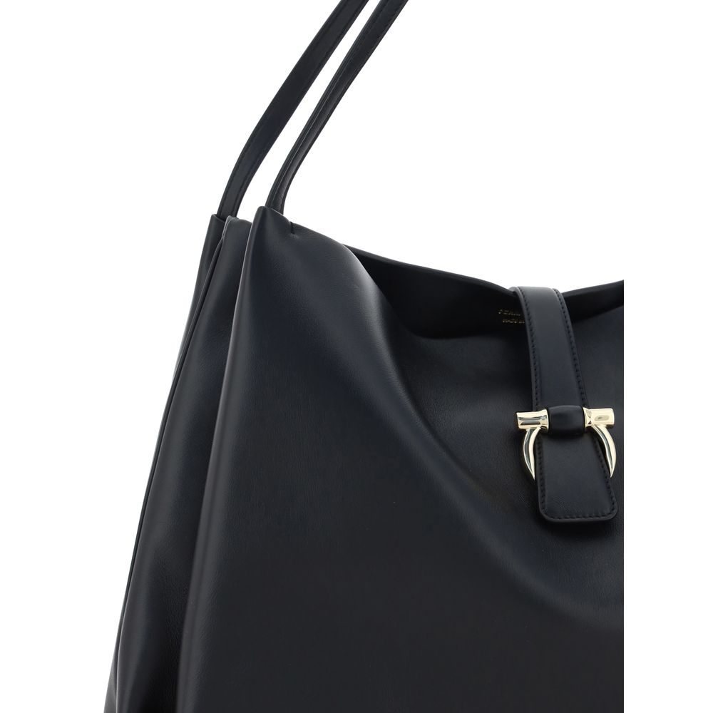 Black Calf Leather Bos Taurus HandbagLeather Handbag by Ferragamo, double flat top handles, magnetic flap top closure, grained leather design, iconic three-dimensional logo applique on front, interior welt pocket. Season: AW25 Dimension: 38x38x17 Composit