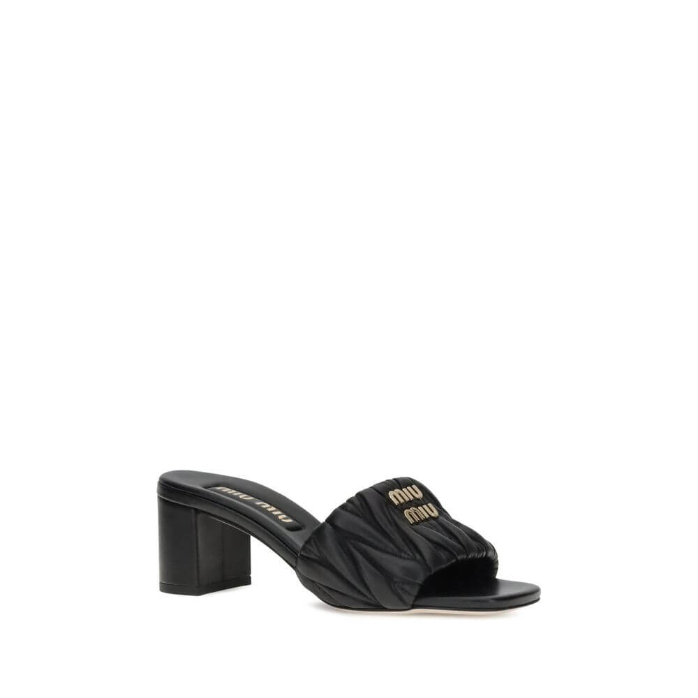 Black Lamb Ovis Aries Aries Stiletto Heel SandalsMiu Miu’s lambskin Sandals combine elegance and comfort in a sophisticated design. With a squared toe and padded straps, they are embellished with a metal plaque featuring the iconic Miu Miu monogram on the