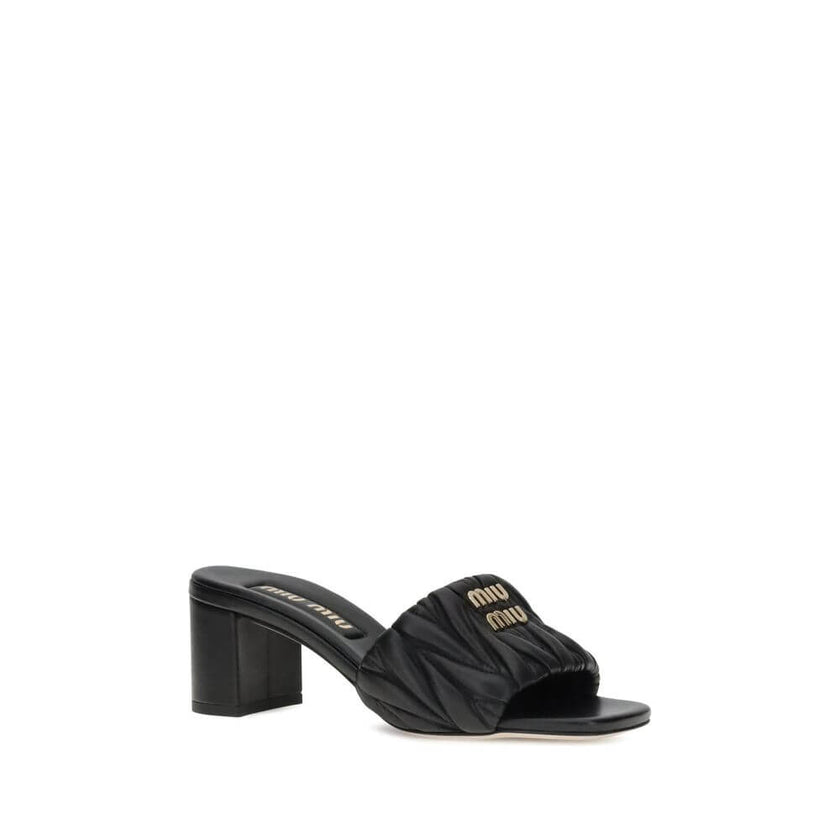 Black Lamb Ovis Aries Aries Stiletto Heel SandalsMiu Miu’s lambskin Sandals combine elegance and comfort in a sophisticated design. With a squared toe and padded straps, they are embellished with a metal plaque featuring the iconic Miu Miu monogram on the