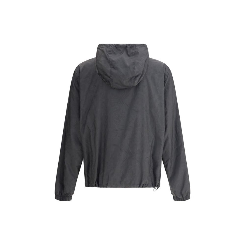 Black Polyester Shell JacketWaterproof Jacket by Versace with a functional and sophisticated design. The design features an adjustable drawstring hood, front zipper closure and two side welt pockets. Elasticized cuffs and an adjustable drawstring hem ensu