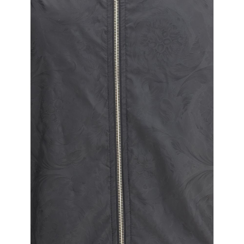 Black Polyester Shell JacketWaterproof Jacket by Versace with a functional and sophisticated design. The design features an adjustable drawstring hood, front zipper closure and two side welt pockets. Elasticized cuffs and an adjustable drawstring hem ensu