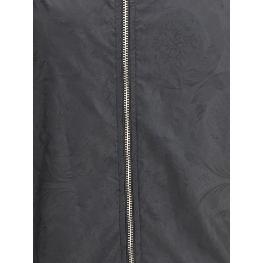 Black Polyester Shell JacketWaterproof Jacket by Versace with a functional and sophisticated design. The design features an adjustable drawstring hood, front zipper closure and two side welt pockets. Elasticized cuffs and an adjustable drawstring hem ensu