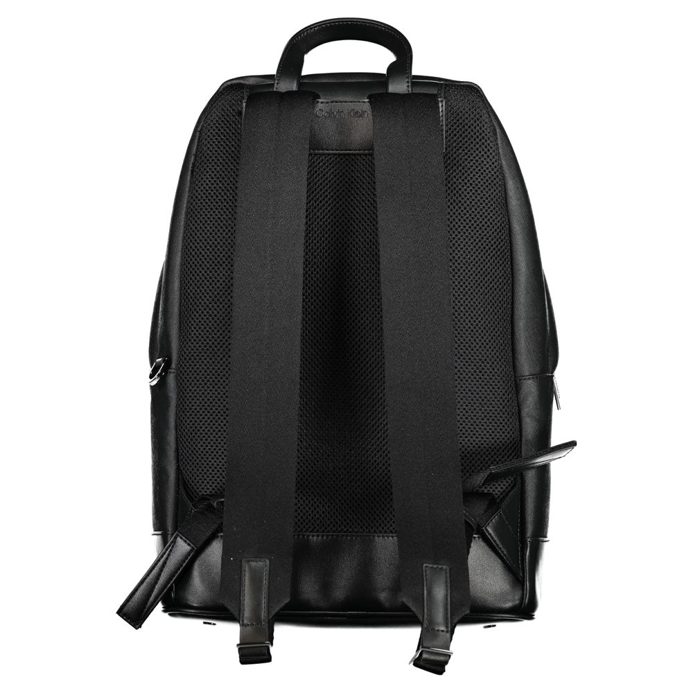 Black Polyester BackpackBACKPACK 1 HANDLE, ADJUSTABLE STRAPS, 1 EXTERNAL POCKET, 1 INTERNAL POCKET, 1 LAP-TOP COMPARTMENT, CONTRASTING DETAILS, ZIP CLOSURE, PROTECTIVE FEET, LOGO, 50% RECYCLED POLYESTERBlack Polyester Backpack${tagsCalvin KleinAulae Black
