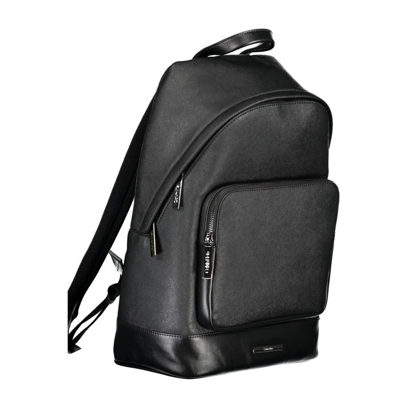 Black Polyester BackpackBACKPACK 1 HANDLE, ADJUSTABLE STRAPS, 1 EXTERNAL POCKET, 1 INTERNAL POCKET, 1 LAP-TOP COMPARTMENT, CONTRASTING DETAILS, ZIP CLOSURE, PROTECTIVE FEET, LOGO, 50% RECYCLED POLYESTERBlack Polyester Backpack${tagsCalvin KleinAulae Black