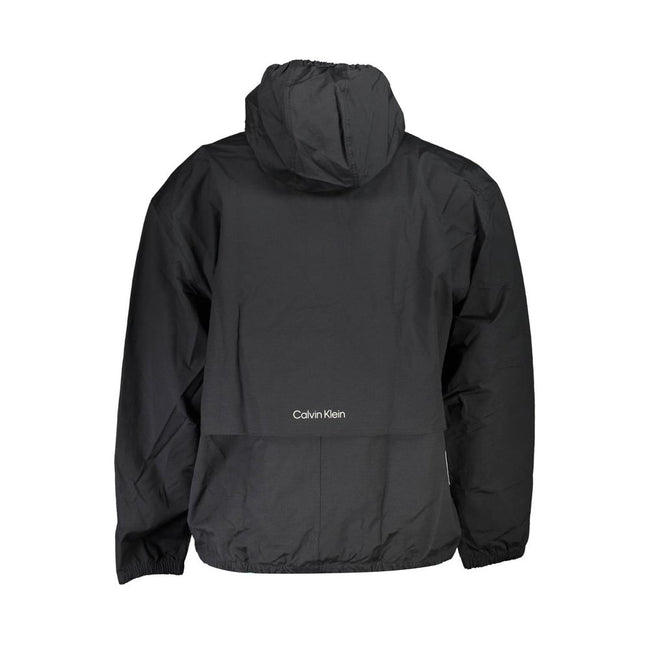 Black Cotton Men's JacketIntroducing the sleek and versatile Calvin Klein sports jacket – the ultimate fusion of functionality and style. Crafted for those who dare to stand out, this black jacket boasts long sleeves, a practical hood, and a smart zip clo