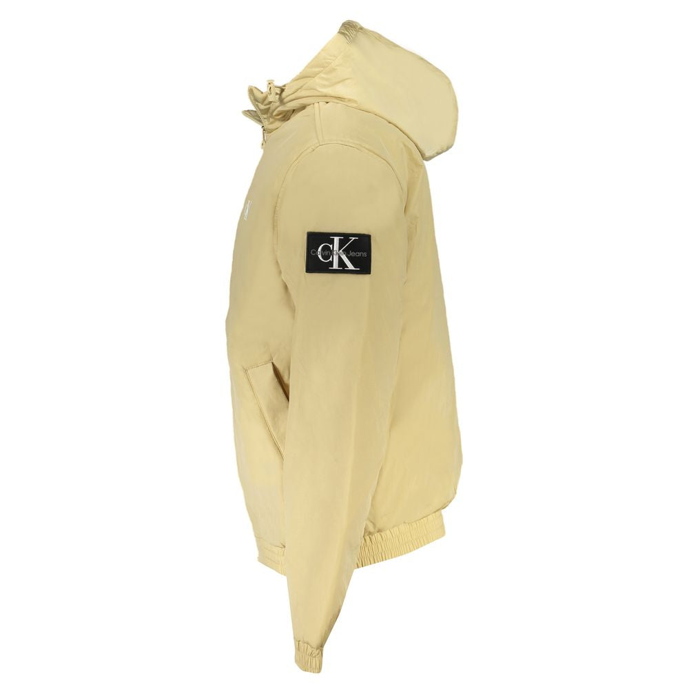 Beige Recycled Polyester Men JacketElevate your wardrobe with the unmistakable sophistication of Calvin Klein. This beige long-sleeved jacket is tailored for the fashion-forward individual. Adorned with a subtle print and the iconic logo, it offers style