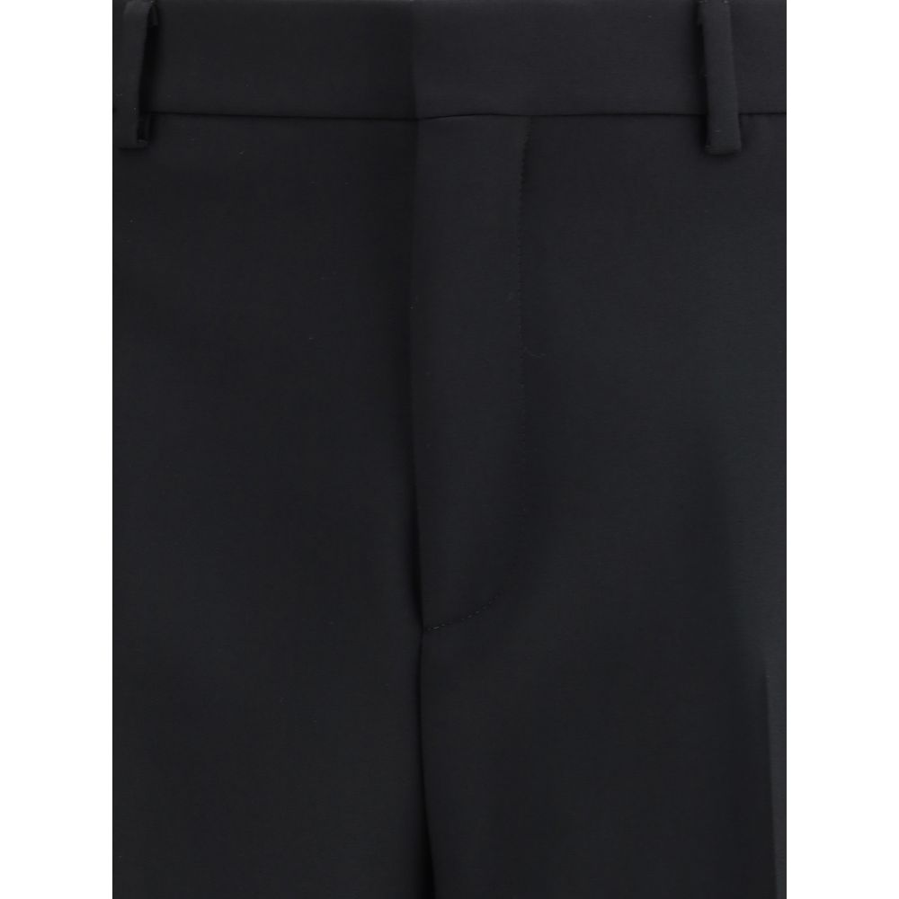 Black Wool Dress PantsGucci’s Wool Pants feature Double G embroidery, the house’s iconic symbol. They feature a hidden inside waist seam, belt loops, two side slash pockets and two back pockets. The split hem adds a modern detail, while the button-and-zip