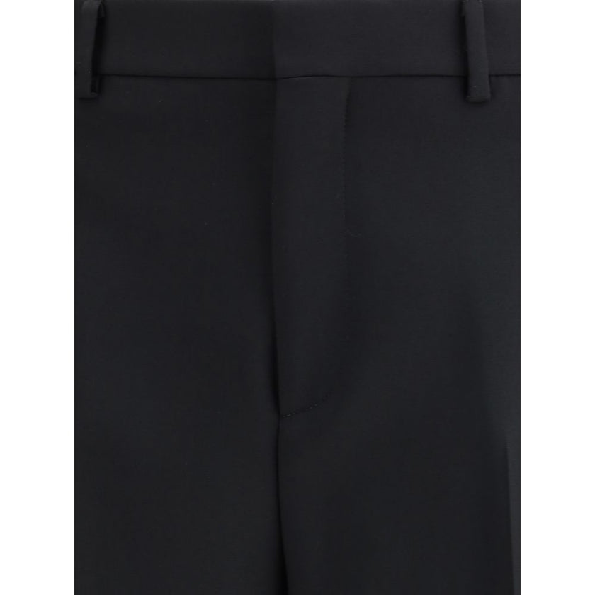 Black Wool Dress PantsGucci’s Wool Pants feature Double G embroidery, the house’s iconic symbol. They feature a hidden inside waist seam, belt loops, two side slash pockets and two back pockets. The split hem adds a modern detail, while the button-and-zip