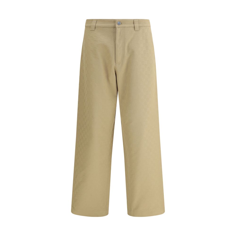 Beige Cotton Casual PantsGucci’s cotton Pants combine a functional design with a distinctive aesthetic. Featuring an all-over GG pattern, they feature belt loops, a carpenter-style pocket and back pockets. The button and zipper closure completes the look