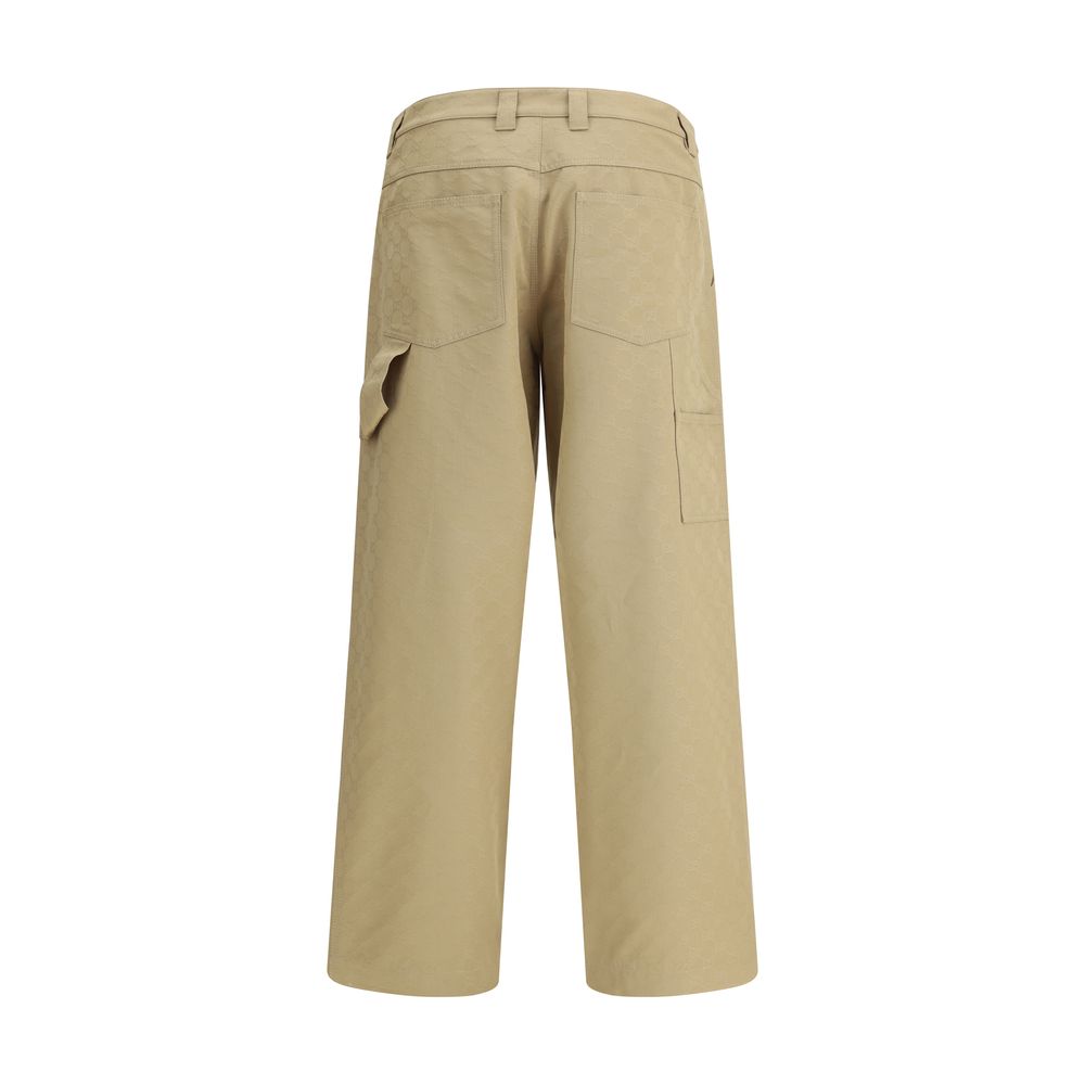 Beige Cotton Casual PantsGucci’s cotton Pants combine a functional design with a distinctive aesthetic. Featuring an all-over GG pattern, they feature belt loops, a carpenter-style pocket and back pockets. The button and zipper closure completes the look