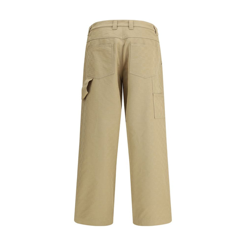 Beige Cotton Casual PantsGucci’s cotton Pants combine a functional design with a distinctive aesthetic. Featuring an all-over GG pattern, they feature belt loops, a carpenter-style pocket and back pockets. The button and zipper closure completes the look