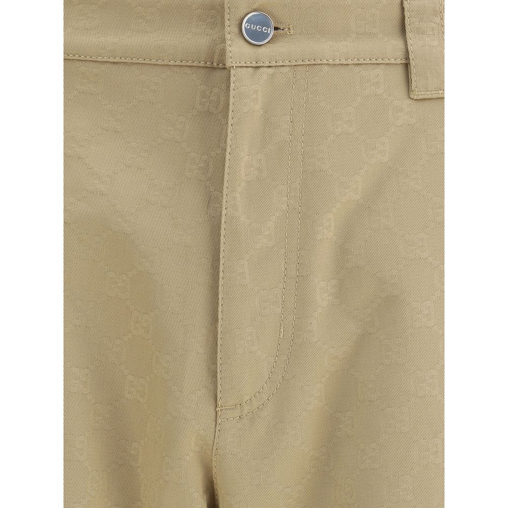 Beige Cotton Casual PantsGucci’s cotton Pants combine a functional design with a distinctive aesthetic. Featuring an all-over GG pattern, they feature belt loops, a carpenter-style pocket and back pockets. The button and zipper closure completes the look