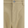 Beige Cotton Casual PantsGucci’s cotton Pants combine a functional design with a distinctive aesthetic. Featuring an all-over GG pattern, they feature belt loops, a carpenter-style pocket and back pockets. The button and zipper closure completes the look