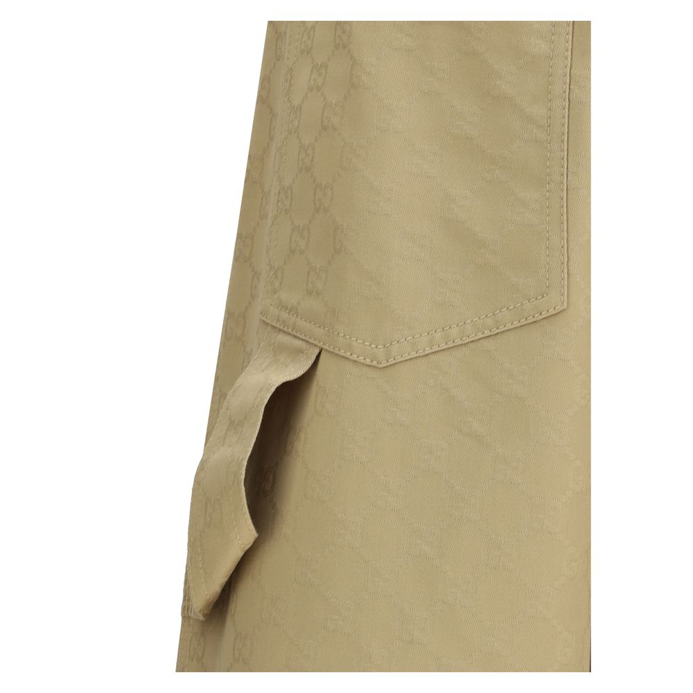 Beige Cotton Casual PantsGucci’s cotton Pants combine a functional design with a distinctive aesthetic. Featuring an all-over GG pattern, they feature belt loops, a carpenter-style pocket and back pockets. The button and zipper closure completes the look