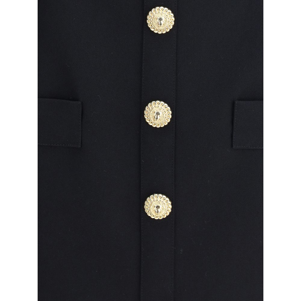 Black Fleece Wool Casual DressBalmain’s Sleeveless Short Dress is a garment with a structured cut and strong elegance. Featuring a classic collar and embossed buttons reminiscent of the house’s iconic style, it has two welt pockets on the front that add a
