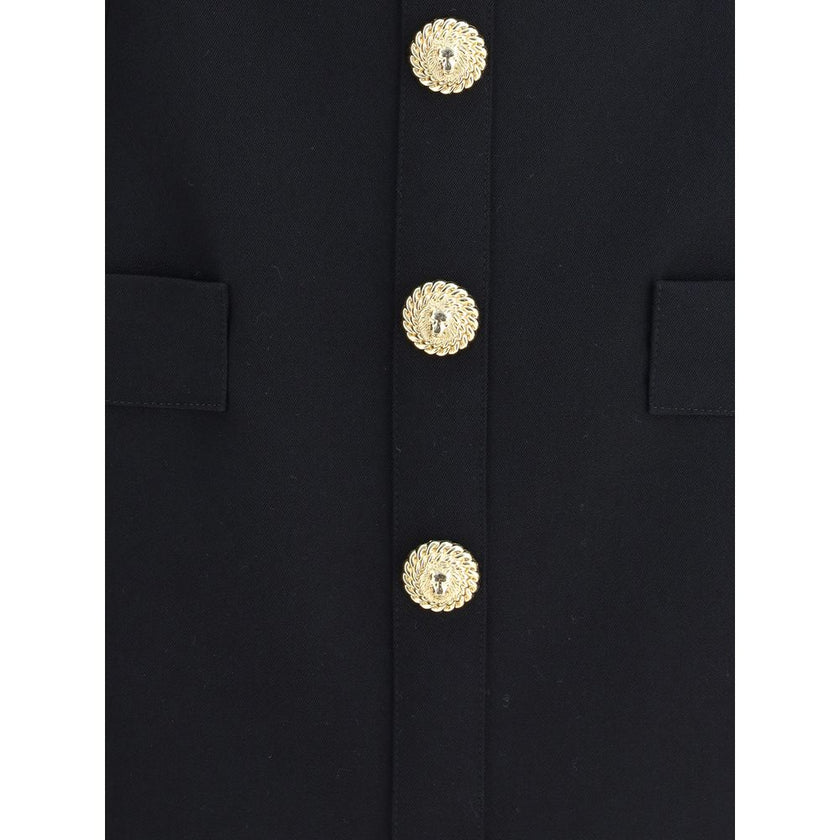 Black Fleece Wool Casual DressBalmain’s Sleeveless Short Dress is a garment with a structured cut and strong elegance. Featuring a classic collar and embossed buttons reminiscent of the house’s iconic style, it has two welt pockets on the front that add a