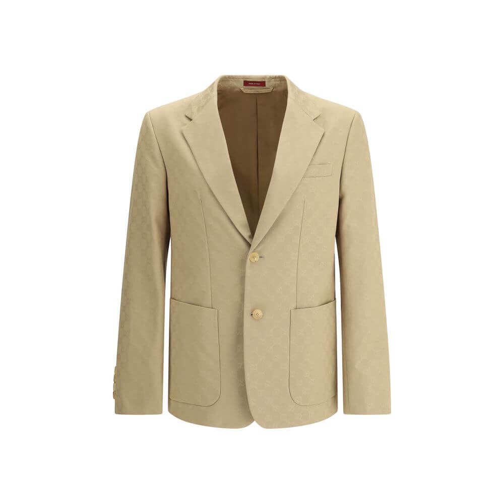 Beige Cotton BlazerGucci’s GG jacquard blazer is an elegant and distinctive piece made of jacquard fabric with the iconic GG pattern. Fully lined, it features a single-breasted button closure, notch lapels, a chest pocket and two front pockets. A perfect