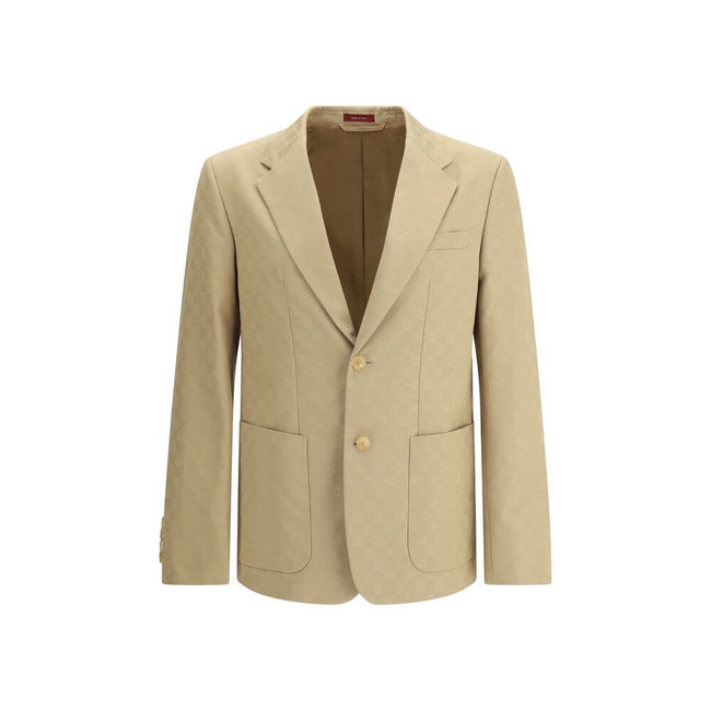 Beige Cotton BlazerGucci’s GG jacquard blazer is an elegant and distinctive piece made of jacquard fabric with the iconic GG pattern. Fully lined, it features a single-breasted button closure, notch lapels, a chest pocket and two front pockets. A perfect