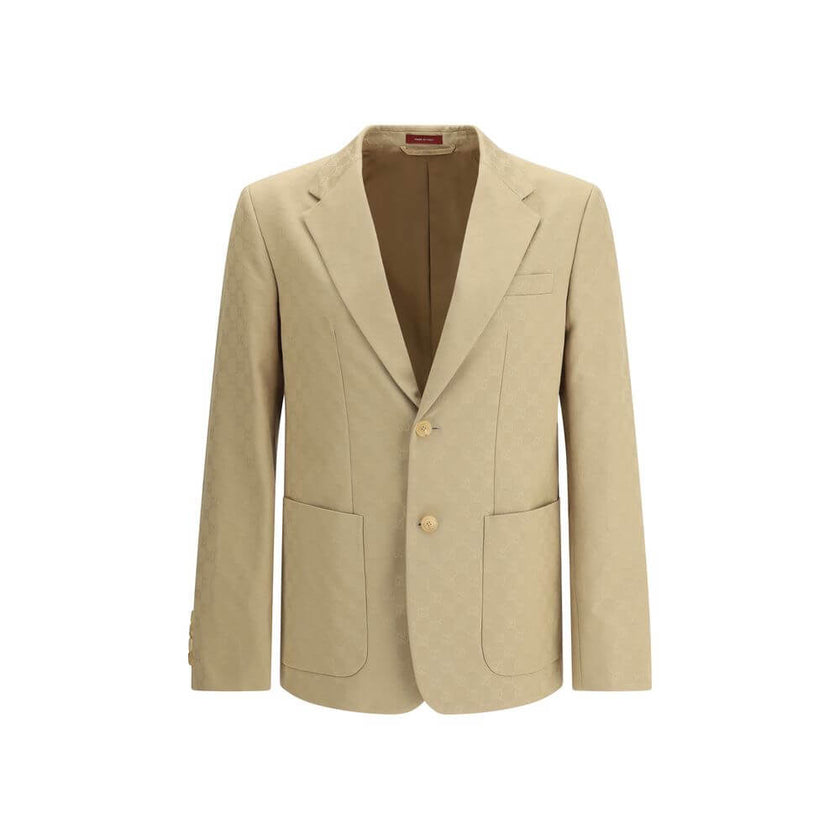 Beige Cotton BlazerGucci’s GG jacquard blazer is an elegant and distinctive piece made of jacquard fabric with the iconic GG pattern. Fully lined, it features a single-breasted button closure, notch lapels, a chest pocket and two front pockets. A perfect