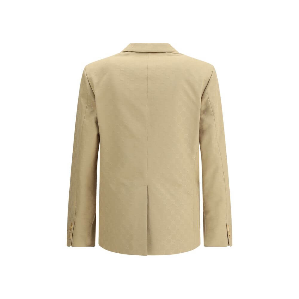 Beige Cotton BlazerGucci’s GG jacquard blazer is an elegant and distinctive piece made of jacquard fabric with the iconic GG pattern. Fully lined, it features a single-breasted button closure, notch lapels, a chest pocket and two front pockets. A perfect