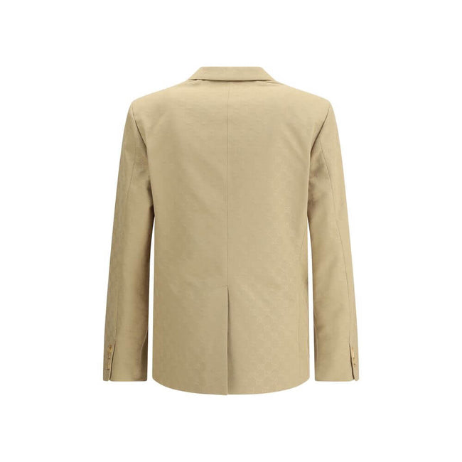 Beige Cotton BlazerGucci’s GG jacquard blazer is an elegant and distinctive piece made of jacquard fabric with the iconic GG pattern. Fully lined, it features a single-breasted button closure, notch lapels, a chest pocket and two front pockets. A perfect