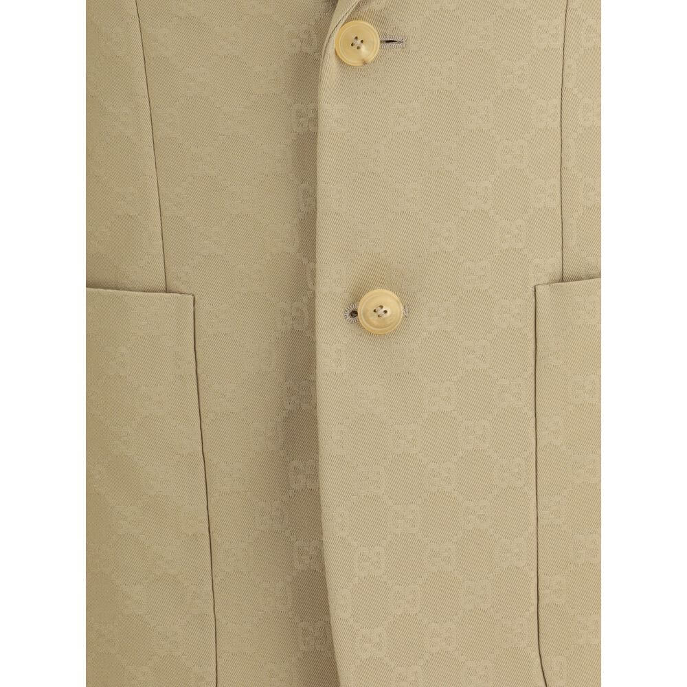 Beige Cotton BlazerGucci’s GG jacquard blazer is an elegant and distinctive piece made of jacquard fabric with the iconic GG pattern. Fully lined, it features a single-breasted button closure, notch lapels, a chest pocket and two front pockets. A perfect