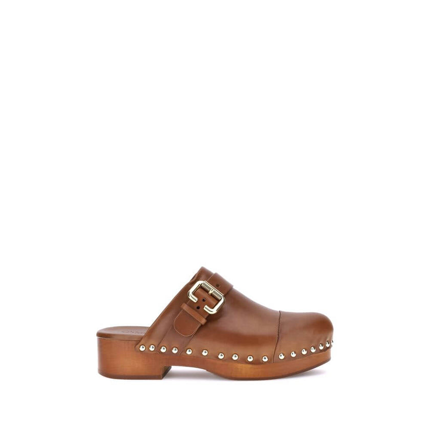 Brown Calf Leather Bos Taurus ClogsChloé’s Jeannette Mules reinterpret the classic clog model with a bold, contemporary style. Made of soft calfskin, they feature a solid wooden platform and a low wide heel for stability and comfort. The round toe, golden