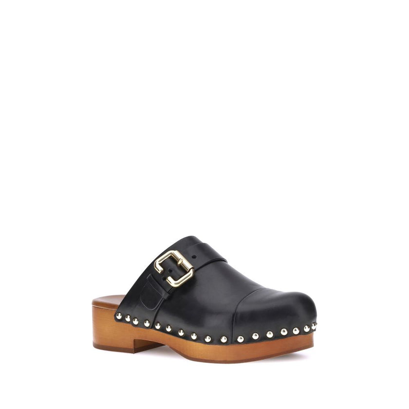 Black Calf Leather Bos Taurus ClogsChloé’s Jeannette Mules reinterpret the classic clog model with a bold, contemporary style. Made of soft calfskin, they feature a solid wooden platform and a low wide heel for stability and comfort. The round toe, golden