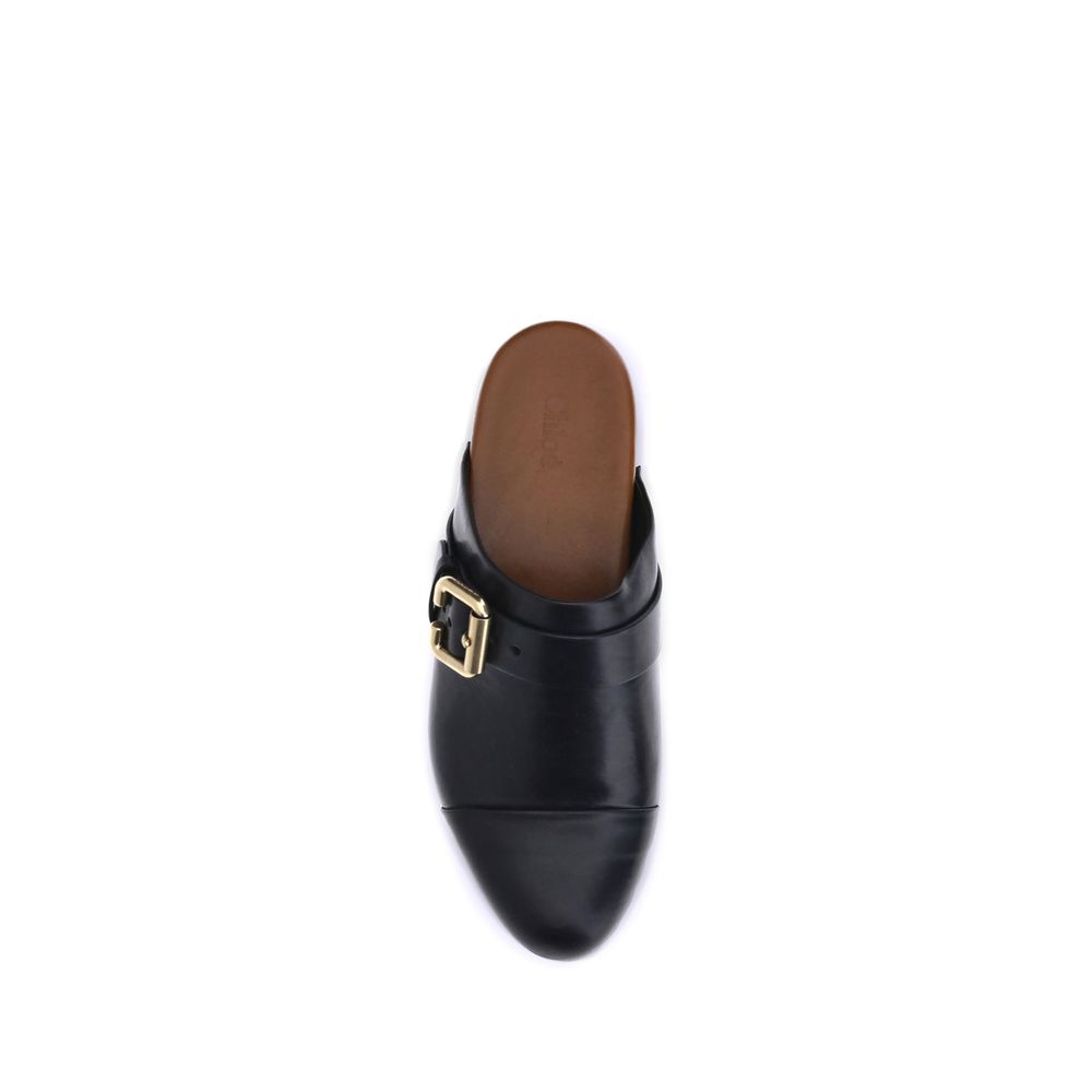 Black Calf Leather Bos Taurus ClogsChloé’s Jeannette Mules reinterpret the classic clog model with a bold, contemporary style. Made of soft calfskin, they feature a solid wooden platform and a low wide heel for stability and comfort. The round toe, golden