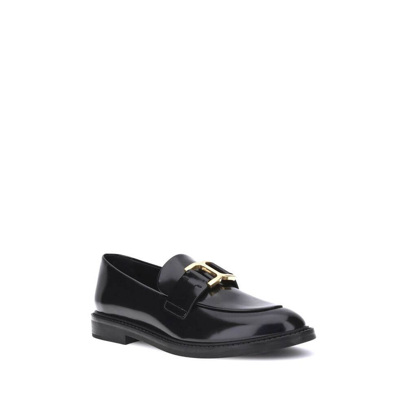 Black Calf Leather Bos Taurus Slip-On LoafersMarcie Loafers by Chloé combine classic elegance with refined details. Crafted with a glossy finish, they are embellished with refined gold-tone detailing and embossed stitching that enhance their craftsmanship