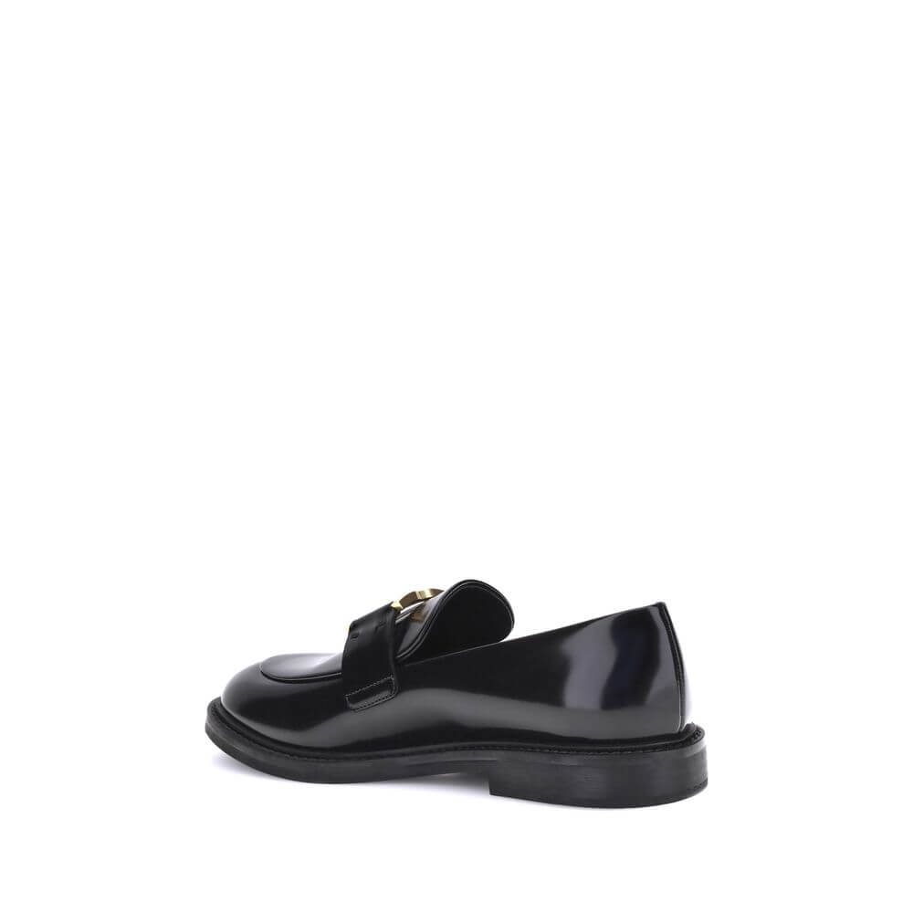 Black Calf Leather Bos Taurus Slip-On LoafersMarcie Loafers by Chloé combine classic elegance with refined details. Crafted with a glossy finish, they are embellished with refined gold-tone detailing and embossed stitching that enhance their craftsmanship